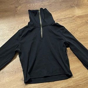 Long sleeve crop top. Can be worn with zipper down.